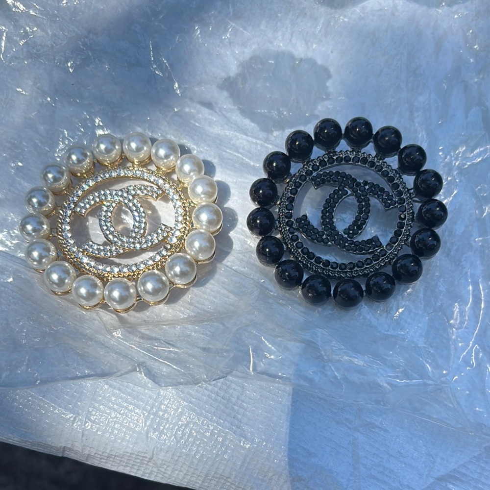 CHANEL Gold and Black Brooch Collection
